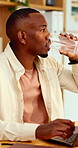 Drinking, water and man with laptop in business, copywriting and planning for article or reflection. Copywriter, thinking and black person with technology, creative and mineral on break in office