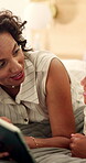 Boy, tablet and talking with mother in bedroom of home for bonding, connection or streaming. App, son and videos with mom on bed in apartment for development or subscription as African family
