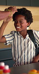 Family, high five and child with backpack in kitchen, back to school or getting ready with happy boy. Childcare, home and morning routine with parent, education and person with support for kid