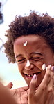 Hands, boy and sunscreen on face for holiday, sunburn prevention and UV protection or skin damage. African family, mother and spf lotion application on child for summer swimming, skincare or wellness
