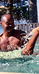 Swimming, pool and dad with child for learning, aquatic skills and playful development or exercise. Black family, splash and father with son for water sports, health and wellness together outdoors