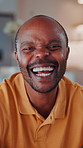 Happy, face and black man laughing in home with pride for funny joke, humor or comedy. Portrait, African male person or smile with positive attitude for morning break, holiday or weekend in house