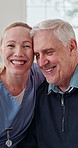 Happy, nurse and senior patient with hug in retirement house for assisted living, support or help. Healthcare worker, caregiver or smile with elderly man for medical assistance in nursing home