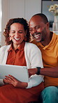 Laughing, couple and chill with tablet in home, entertainment and watching comedy on break in lounge. Interracial, relationship and mature people with technology, happy and funny movies in house