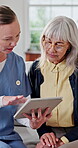 Nurse, old woman and tablet for healthcare with advice, consulting or feedback in retirement home. App, conversation and medical report with caregiver speaking to senior patient for checkup or visit