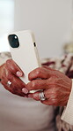Hands, phone and typing with old woman in living room of home for communication or social media. App, search and text message with senior person on sofa in apartment for browsing, download or post