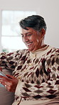 Tablet, relax and senior woman on sofa with smile, social media or ebook on mobile app in home. Entertainment, retirement and happy elderly person with tech for blog post and reading in living room