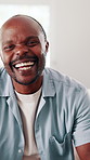 Face, black man and relax at house with smile, peace and comfortable for weekend break on sofa. Portrait, male person and laugh in home with positive attitude, stress free and calm morning to unwind