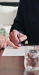 Advice, hands and signature of old person in home for insurance or investment sign up. Documents, finance and senior man with security broker in apartment for contract, policy or wealth management