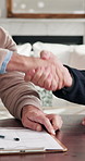 Property, sale or handshake in house with contract, offer acceptance or deal closing in meeting. Partnership, men or realtors with shaking hands, home transfer or success in investment negotiation.