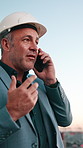 Architect, man and phone call in city for construction planning, project development or evaluation. Mobile, engineer and mature person talk to contact outdoor for building compliance or communication