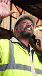 Phone call, black man and construction worker on site with feedback on property development or repairs. Cellphone, contact and civil engineer on mobile discussion for building approval from below.