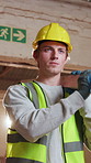 Carpentry, walking and man in workshop with plank, timber material and stock for woodworking. Construction, thinking and person with wood for lumber production, manufacturing and furniture project