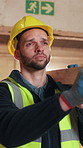 Carpentry, walking and man in warehouse with plank, timber material and stock for woodworking. Construction, contractor and person with wood for lumber production, manufacturing and furniture project