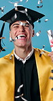 Face, graduation and man in studio with confetti for education, achievement and college success. Graduate, happy and portrait of person for university celebration and milestone on blue background
