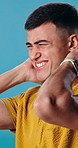 Frustrated, man and studio with neck pain for massage, injury or discomfort on a blue background. Male person, sore spine or muscle tension with ache for joint inflammation, strain or pressure