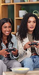 Happy, laugh and friends on sofa for video games, online competition and playing together for bonding. Home, relax and women with controller for entertainment, virtual challenge or hangout on weekend