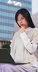 Journalist, thinking or asian woman with laptop in city for online research, network or article. Thoughtful, freelancer or happy female person with computer for story writing or publish in urban town