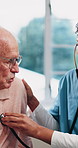 Woman, nurse and listening to heart beat with senior patient for health checkup or breathing exam. Female person, healthcare worker or monitoring elderly man with stethoscope for medical aid or help