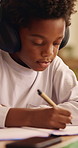 Writing, headphones and kid with book for education, homework and learning in home. Study, notebook and african child with tech for lesson tips, development and productivity with audio assessment