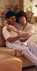 Happy, couple and watching tv on home sofa with love, connection and healthy relationship. Man, woman or pyjamas with remote control in lounge for comfort, movie or change channel for entertainment