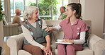 Senior, nurse or tablet with blood pressure machine in retirement home for medical checkup. Female person, caregiver or healthcare worker with arm strap or technology for elderly care or hypertension