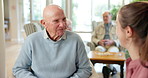Laugh, talk and elderly man with caregiver for support, help or funny joke in home for wellness. Nurse, retirement or communication with happy patient for story, medical healthcare or senior care