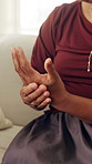 Home, woman and hand pain with arthritis, injury and talking in consultation for medical visit. Person, sore and joint ache in living room with nerve inflammation, fibromyalgia and health risk