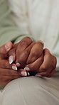 Love, holding hands and couple in home for connection, bonding or support in marriage in living room. Trust, comfort and man with woman for commitment, safety or solidarity in relationship at house.