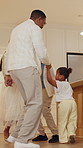 Dancing, smile and black family in home with music, radio or playlist for bonding together. Happy, connection and children with parents for moving to song on album in kitchen at apartment on weekend.