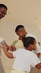 Dancing, happy and black family in home with music, radio or playlist for bonding together. Smile, connection and children with parents for moving to song on album in kitchen at apartment on weekend.