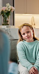 Child, talking and therapist at house for counseling, consultation and guidance for psychology. Psychologist, kid and checkup on sofa for home visit, therapy session and advice of behavior assessment