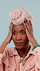Anxiety, stress and black woman with hands on head in studio for mistake, crisis or disaster. Fear, face and African person shocked with fake news, debt or wrong choice for fail on blue background