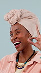 Black woman, okay hand and wink in studio with review, agreement and support with smile. Feedback, like emoji and yes with portrait for success, gesture and thanks or promo on blue background