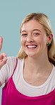 Smile, woman and face in studio for agreement, ok sign and feedback or vote hand gesture. Review, yes and opinion with female person for support, portrait or promotion with win on blue background