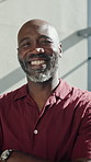 Face, creative and black man in office with arms crossed, career pride and about us for copywriting. Portrait, mature person and smile in workplace with ambition, news reporter and public relations