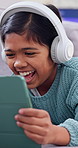 Laugh, headphones and child on sofa on tablet for streaming, watching videos and relax on weekend. Happy, home and girl on tech for cartoon subscription, internet and funny movie for entertainment