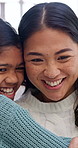 Happy, hug and mother with kid in home for bonding, love and family connection on weekend. Smile, technology and mom embracing girl child in living room for trust, safety or affection in apartment.