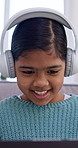 Happy, headphones and child on sofa on tech for streaming, watching videos and relax on weekend. Laugh, home and girl on laptop for music subscription, internet and listening to song for good mood