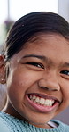 Happy, calm and face of child in home with growth on weekend break, holiday or vacation. Laugh, confident and portrait of girl kid with positive attitude, pride or development in living room at house
