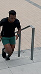 Fitness, stairs and black man in city with running, cardio or stamina challenge in physical activity. Training, above and athlete outdoor with steps, jogging hobby or workout endurance in Los Angeles