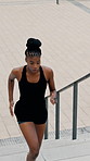 Fitness, stairs and black woman in city with running, cardio or stamina challenge in physical activity. Training, above and athlete with steps, jogging hobby and workout endurance in Los Angeles.