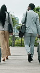 Suitcase, travel and walking with business people outdoor for international visit from back. Conversation, luggage and trip overseas with employee team in city for foreign expansion or networking