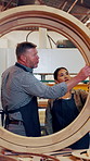Carpenter, team and planning in workshop, wood discussion or production inspection with circle frame. Woodwork, people and check quality, furniture manufacturing or structural integrity evaluation