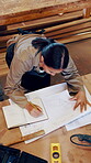 Architecture, woman and writing by blueprint in workshop with wood, notes and layout for process. Above, woodworking and manufacturing in factory for floor plan, project and production for design