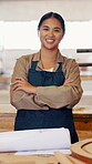 Carpenter, woman and face with arms crossed in workshop with paperwork, planning and confidence. Happy, woodworking and manufacturing in factory for handmade, custom and production of design