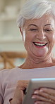 Laugh, tablet and senior woman in home with funny meme, blog or online newsletter in living room. Happy, digital technology and elderly person in retirement watching comedy video on app in house.