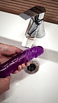 Cleaning, sink and hands of person with sex toy for hygiene, germ prevention and maintenance. Bathroom, home and woman with soap, water and sensual accessory for wellness, washing and disinfection