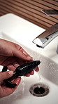 Hygiene, sink and hands of person with sex toy for washing, germ prevention and maintenance. Bathroom, home and woman with faucet, water and sensual accessory for wellness, cleaning and disinfection