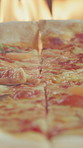 Closeup, flames and cooking pizza for lunch, melting cheese and Italian recipe for fast food. Fire, oven or baking at pizzeria with flatbread, traditional cuisine and gourmet takeaway for hospitality